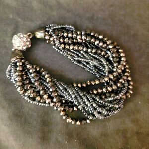 Multistrand bracelet in metallic silver tones with Rhinestone magnetic clasp